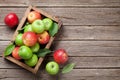 Green and red apples in wooden box Royalty Free Stock Photo