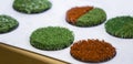 Green and red artificial turf rolled. Probes examples of artificial turf, floor coverings for playgrounds Royalty Free Stock Photo
