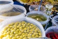 Green, red and black olives, chilies, preserves in a French market in Paris France Royalty Free Stock Photo