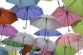 Green, red and blue parasols on a white background.