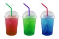 Green, Red and Blue soda and ice in plastic grass isolated