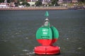 Green red buoy to mark a split in the canal Nieuwe Waterweg in the harbor of Rotterdam