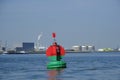 Green red buoy to mark a split in the canal Nieuwe Waterweg in the harbor of Rotterdam