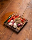 Green and red chili, garlic, and onion on wooden placemats