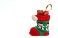 A green red Christmas sock with gifts and candy canes Royalty Free Stock Photo