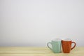 Green and red coffee mug on wooden table. Royalty Free Stock Photo