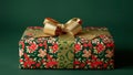Green and red floral gift box with a golden bow on a green background Royalty Free Stock Photo