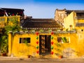 Green and red lanterns hanging outside of an old yellow house in Hoi An ancient town, UNESCO world heritage. Hoi An is Royalty Free Stock Photo