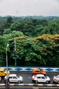 Green and red leaf trees in the park and cars on the road from above with Vidyasagar Setu.