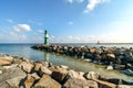 The green and red lighthouses are in view along the coast of Warnemunde Rostock Germany