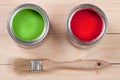 Green and red paint in the bank to repair and brush on the light wooden background Royalty Free Stock Photo