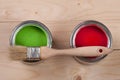 Green and red paint in the bank to repair and brush on the light wooden background Royalty Free Stock Photo