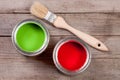 Green and red paint in the bank to repair and brush on the old wooden background Royalty Free Stock Photo