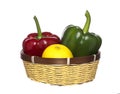 Green, red paprika and lemon in basket, isolated on white Royalty Free Stock Photo