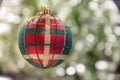 Green And Red Pattern Christmas Decoration Globe With Soft Creamy Bokeh Background