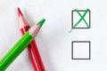 Green and red pencils with marking checkbox
