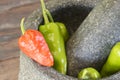 Green and red pepper in mortar Royalty Free Stock Photo