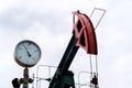 Green and red pumpjack, oil horse, oil derrick pumping oil well with dramatic cloudy sky background Royalty Free Stock Photo