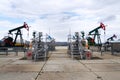 Green and red pumpjack, oil horse, oil derrick pumping oil well with dramatic cloudy sky background Royalty Free Stock Photo