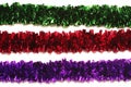 Green, red and purple tinsel isolated on white