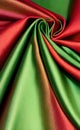 Green and red silk fabric background. Close up of ripples in green silk fabric. A red and green silk texture. Royalty Free Stock Photo