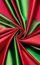 Green and red silk fabric background. Close up of ripples in green silk fabric. A red and green silk texture. Royalty Free Stock Photo