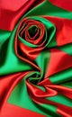 Green and red silk fabric background. Close up of ripples in green silk fabric. A red and green silk texture. Royalty Free Stock Photo