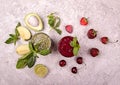 Green and red smoothie of strawberry, sweet cherry, avocado, spinach, basil, lime, green apple on gray background. Healthy diet Royalty Free Stock Photo