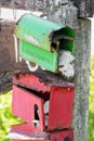 Green and red very old post boxes hanging on pole Royalty Free Stock Photo