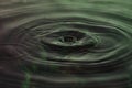 Green and red water dropping, water ripples in a pond. waves of rippling water Royalty Free Stock Photo