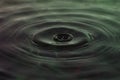 Green and red water dropping, water ripples in a pond. waves of rippling water Royalty Free Stock Photo