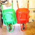 green and red wheelbarrow with flate tires