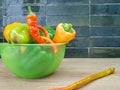 Green, red, yellow bell pepper in a plate on the kitchen work surface Royalty Free Stock Photo