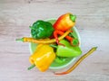 Green, red, yellow bell pepper in a plate on the kitchen work surface Royalty Free Stock Photo