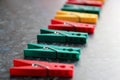 Green, red and yellow plastic clothespins. Color linen clothespins in row. Selective focus Royalty Free Stock Photo