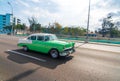 Green retro taxi car with tourists in Havana Cuba Royalty Free Stock Photo