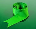 A coiled green ribbon. Royalty Free Stock Photo