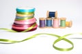Green ribbon close-up with spools of threads Royalty Free Stock Photo