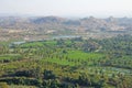 Green rice fields, palms and river Tungabhadra in the village of Hampi. Palm trees, the sun, rice fields. Tropical exotic Royalty Free Stock Photo