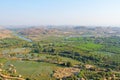 Green rice fields, palms and river Tungabhadra in the village of Hampi. Palm trees, the sun, rice fields. Tropical exotic Royalty Free Stock Photo