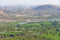 Green rice fields, palms and river Tungabhadra in the village of Hampi. Palm trees, the sun, rice fields. Tropical exotic Royalty Free Stock Photo