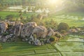 Green rice fields or terraces in the village of Hampi. Palm trees, sun,rice fields, large stones in Hampi. Tropical exotic Royalty Free Stock Photo
