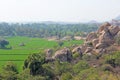 Green rice fields or terraces in the village of Hampi. Palm trees, sun,rice fields, large stones in Hampi. Tropical exotic Royalty Free Stock Photo