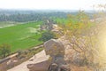 Green rice fields or terraces in the village of Hampi. Palm trees, sun,rice fields, large stones in Hampi. Tropical exotic Royalty Free Stock Photo