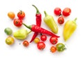 Green and ripe cherry tomatoes, bell peppers, chili on white Royalty Free Stock Photo