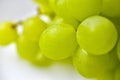 Green ripe grapes macrophotography on a white background Royalty Free Stock Photo