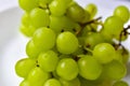 Green ripe grapes macrophotography on a white background Royalty Free Stock Photo
