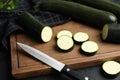 Green ripe zucchinis and wooden board on black slate table, closeup Royalty Free Stock Photo