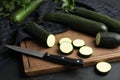 Green ripe zucchinis and wooden board on black slate table Royalty Free Stock Photo