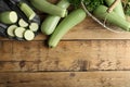 Green ripe zucchinis on wooden table, flat lay. Space for text Royalty Free Stock Photo